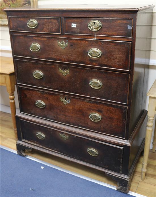 A George III oak chest on stand fitted two short drawers and four graduated long drawers, on bracket feet W.106cm